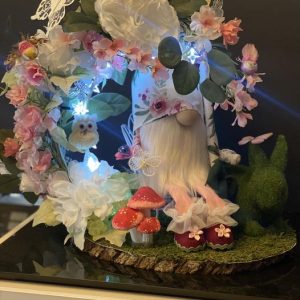 Gnome sitting under a half a moon with the stars